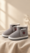 Pair of gray rechargeable heated slippers on a linen cloth